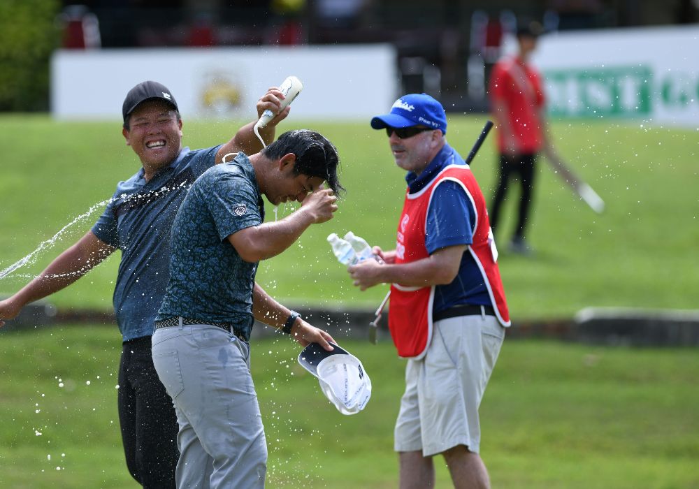 Ervin Chang gets doused by a fellow competitor and Paul San's caddy John Powell